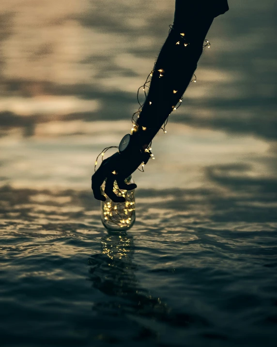 a person walking across a body of water with water droplets