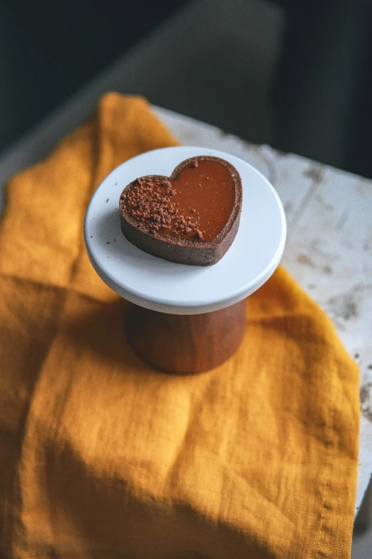 a white plate topped with a chocolate heart