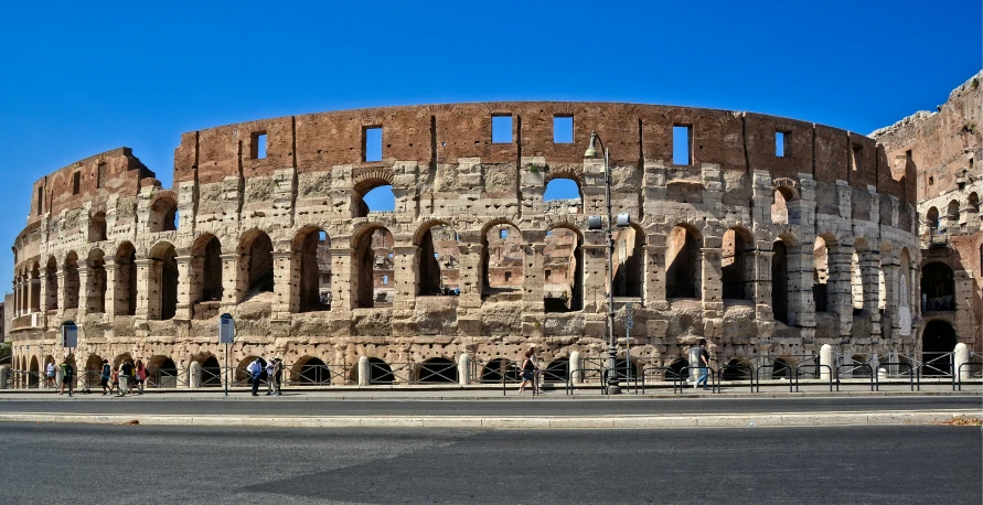 a large roman colgate on the side of the road