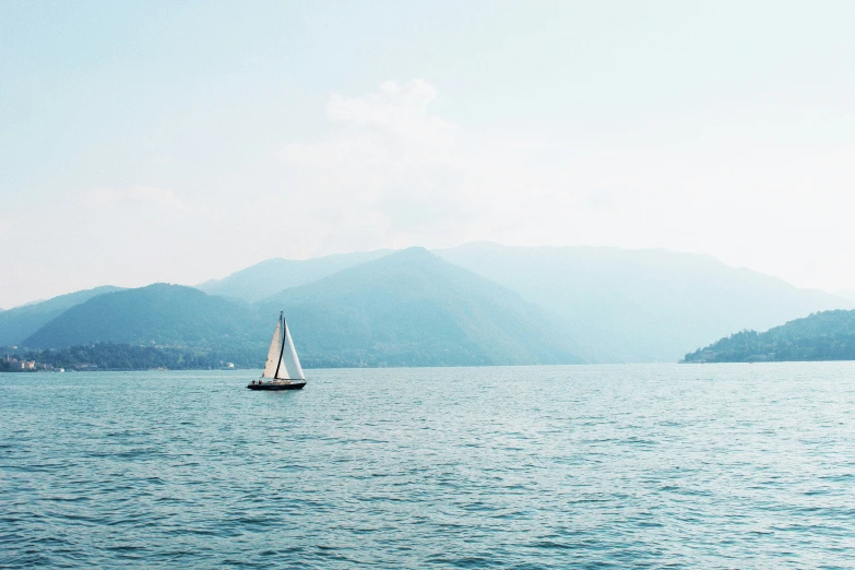 a boat on water with mountains in background