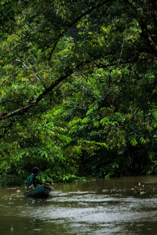 a man sitting in the middle of a river on a raft