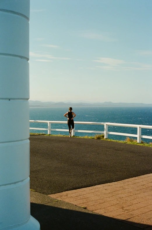 a man running by the ocean and a view from behind