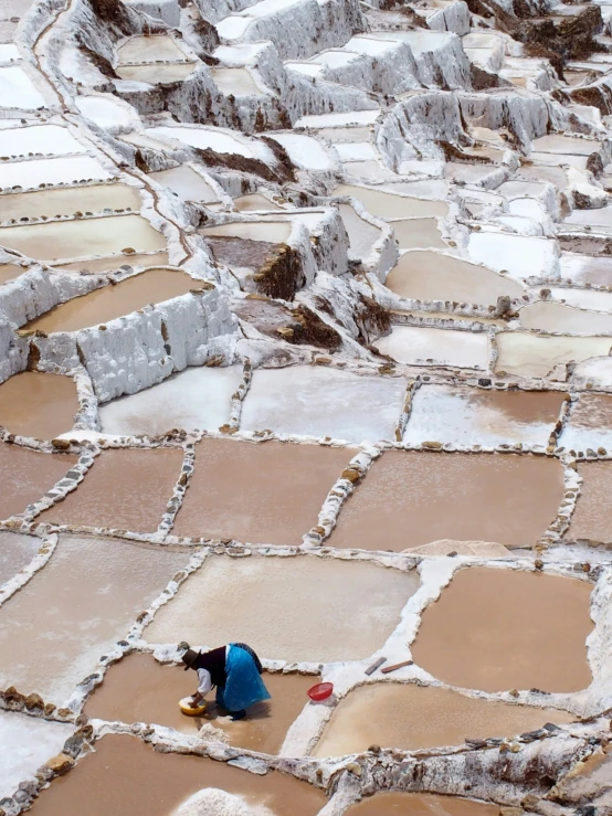 a person in blue jacket sitting on tiled area