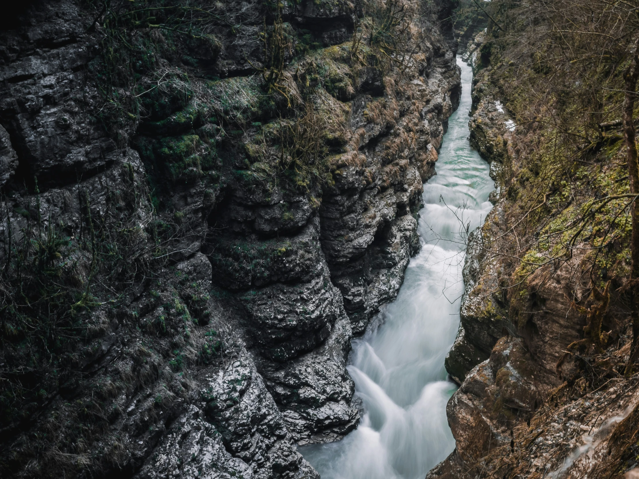 a narrow river in an area with rocky cliffs