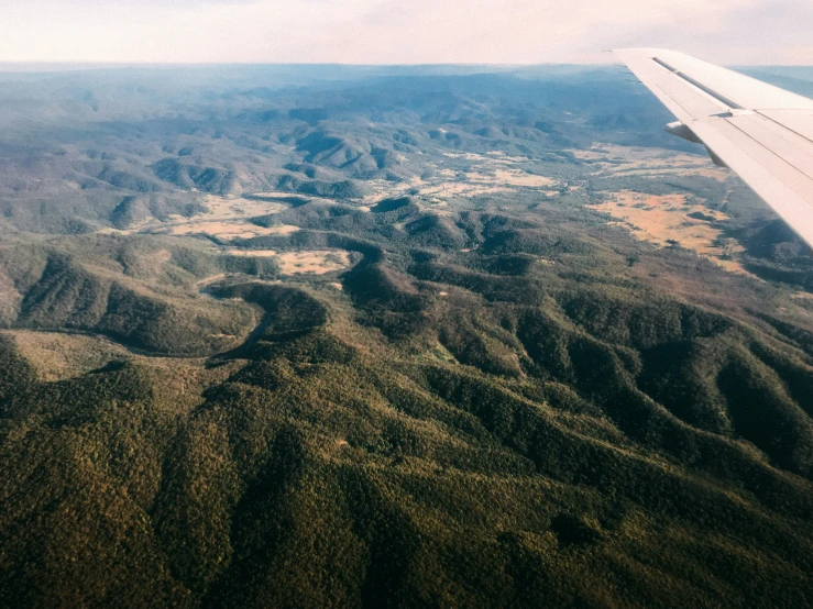 the wing of a plane is visible in flight