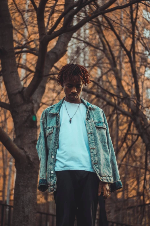 a young person wearing a blue jean jacket