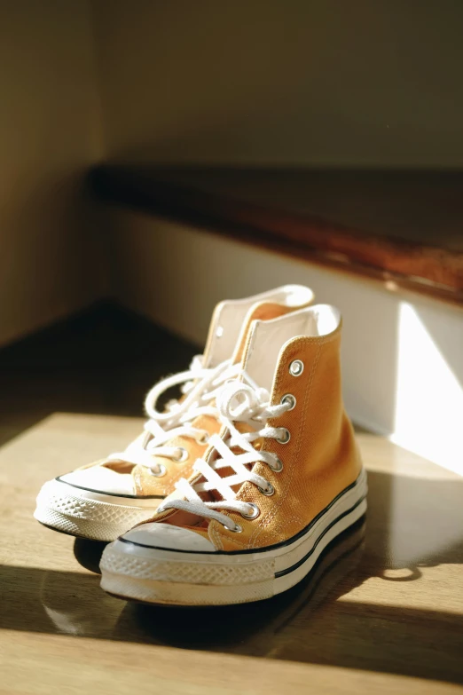 two converse shoes are sitting on a wooden table