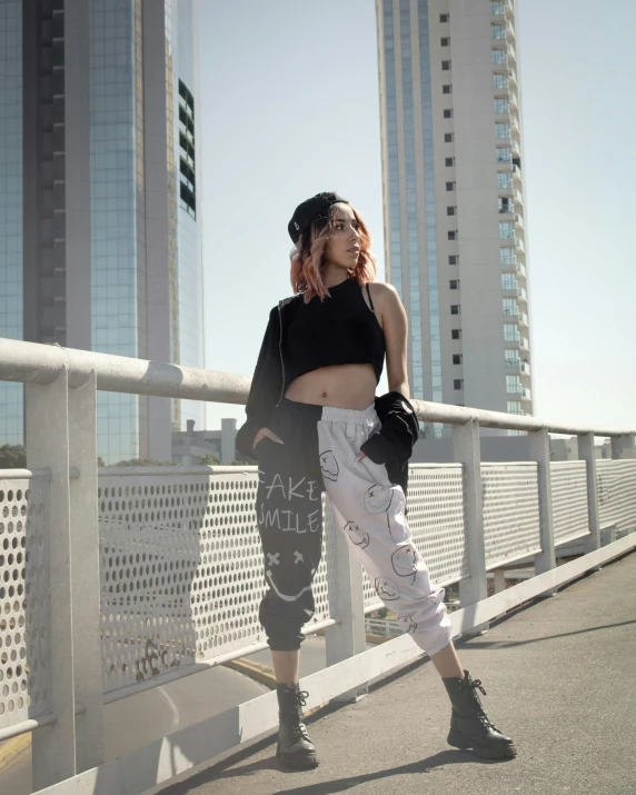 a female is posing with buildings in the background