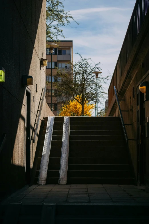 a very long set of stairs with some buildings in the background