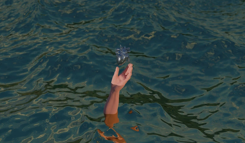 a hand holding an object in the water