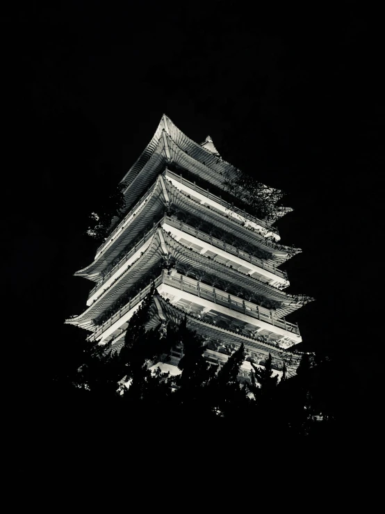 a pagoda is lit up in the dark