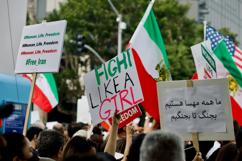 the signs are held up at a protest rally