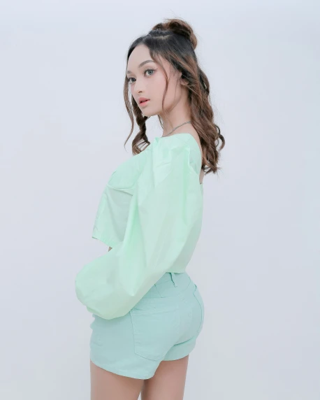 an asian model wearing a mint green top