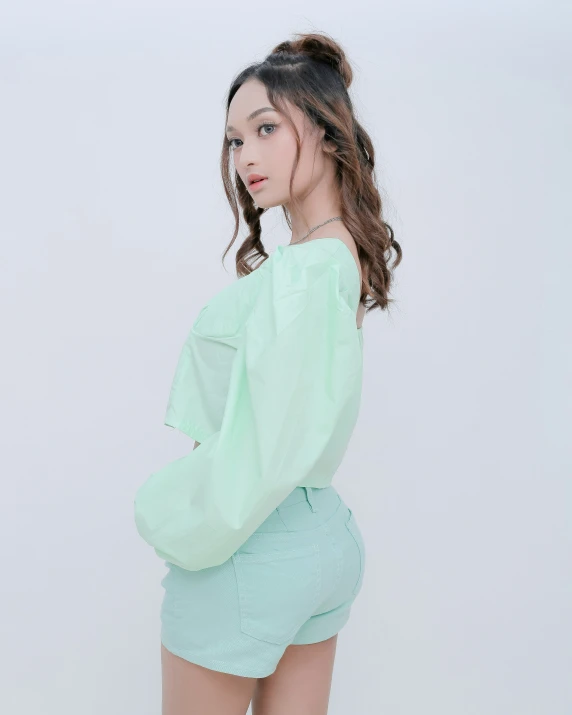 an asian model wearing a mint green top