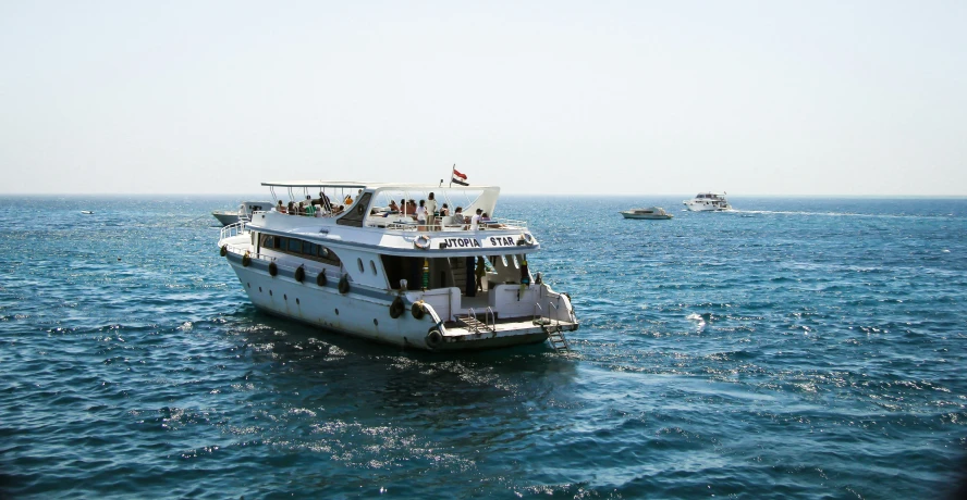 a big boat in the water by the shore