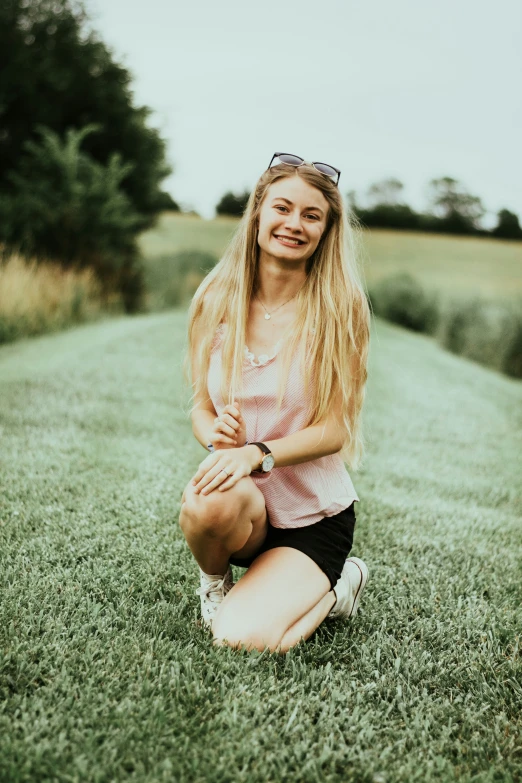 girl sitting in the grass, taking a break