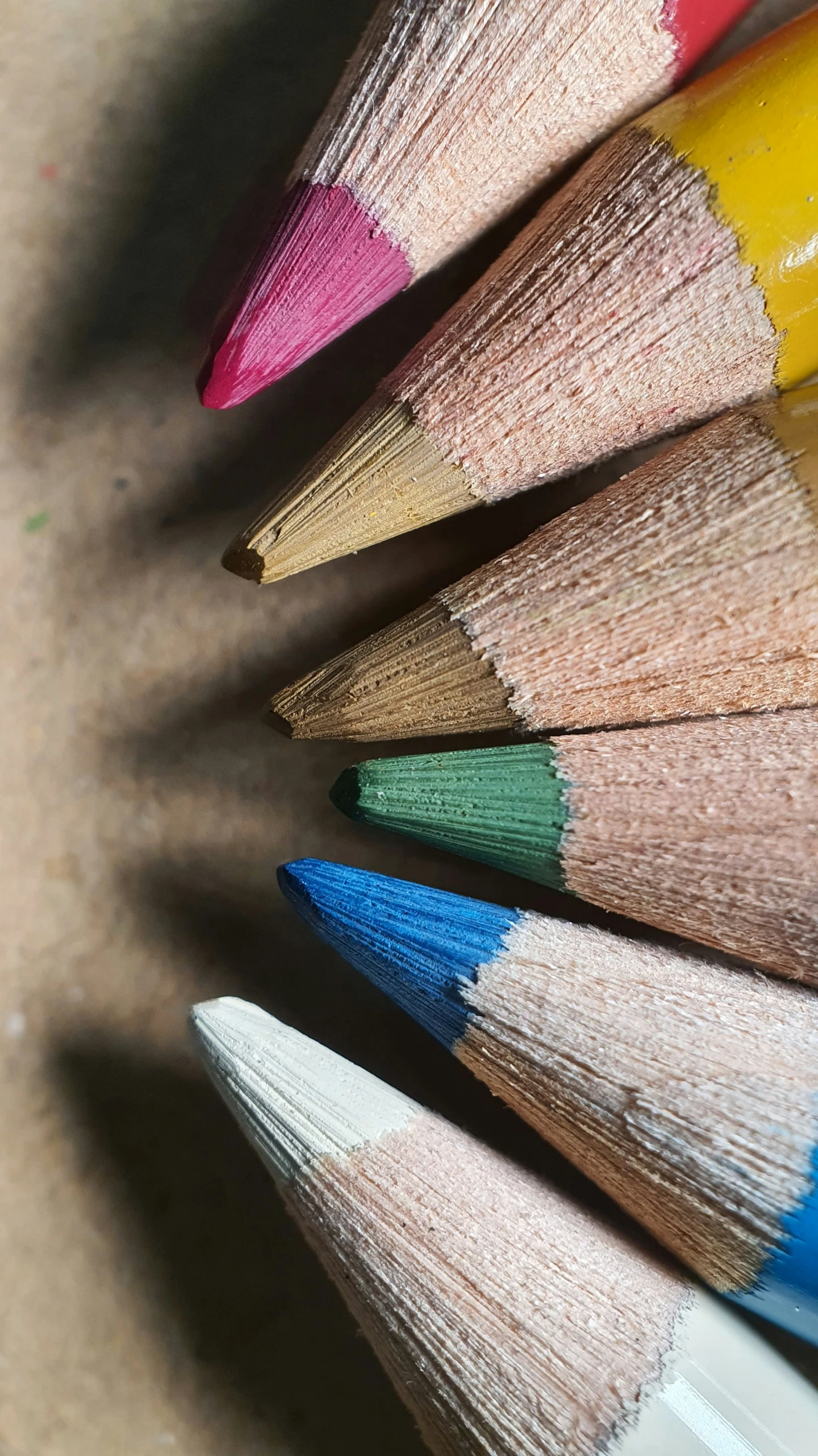 a rainbow of pencils lined up in a circle