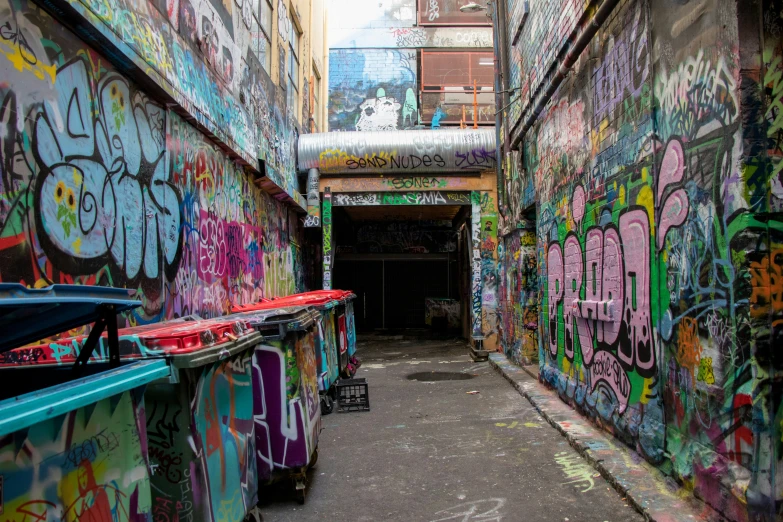 a alley with graffiti all over the walls