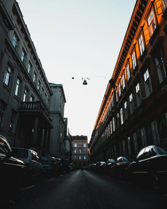 a view of the street from between several buildings in an alley way