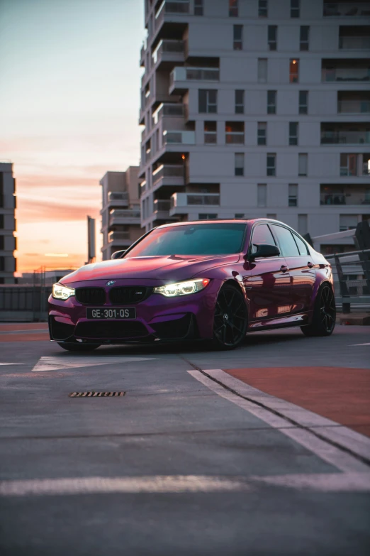 the purple car is driving through the parking lot