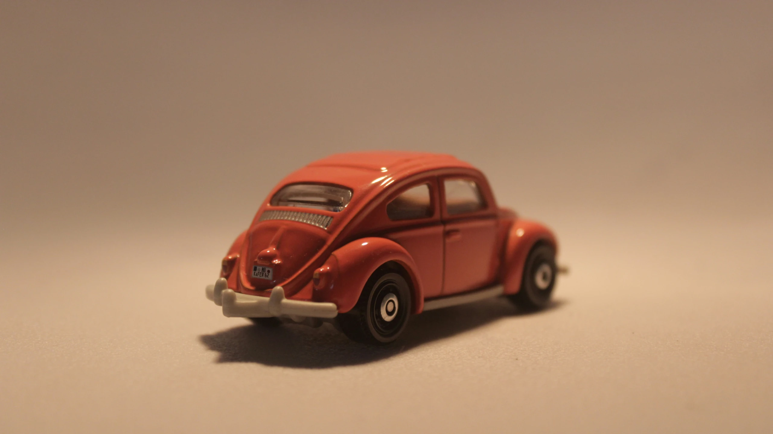 an old model red car that is on the floor