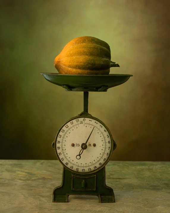an old scale sitting on top of a counter with a apple and a pear