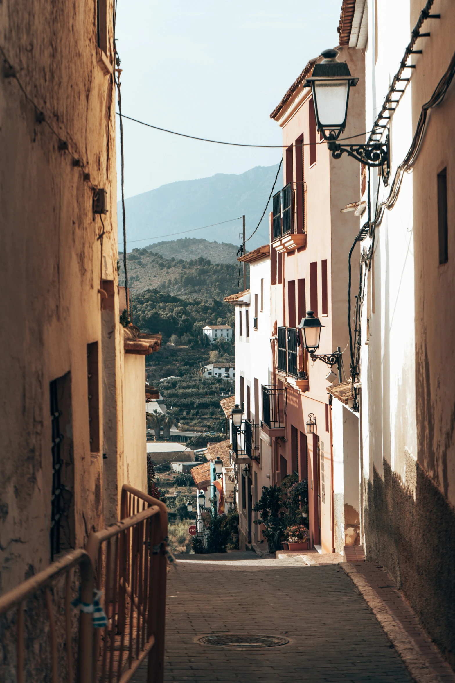 the narrow street in the city has many windows