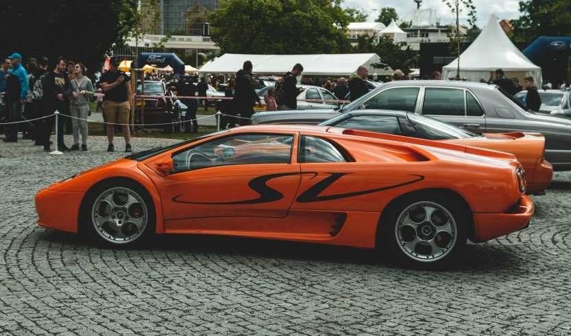 an orange car with some black flames painted on it