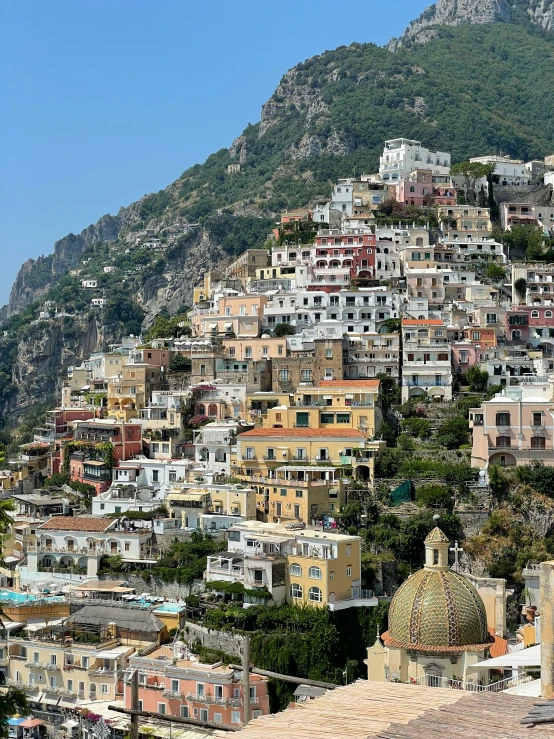 the view of several colorful houses on a hillside