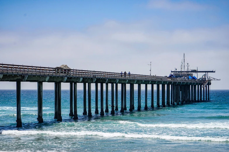 some long pier posts out into the open water