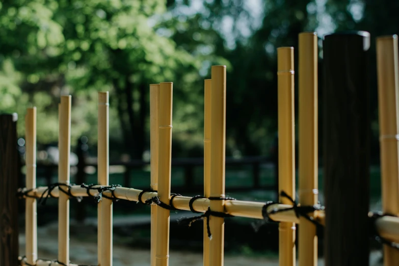 several wooden poles are connected to the rope