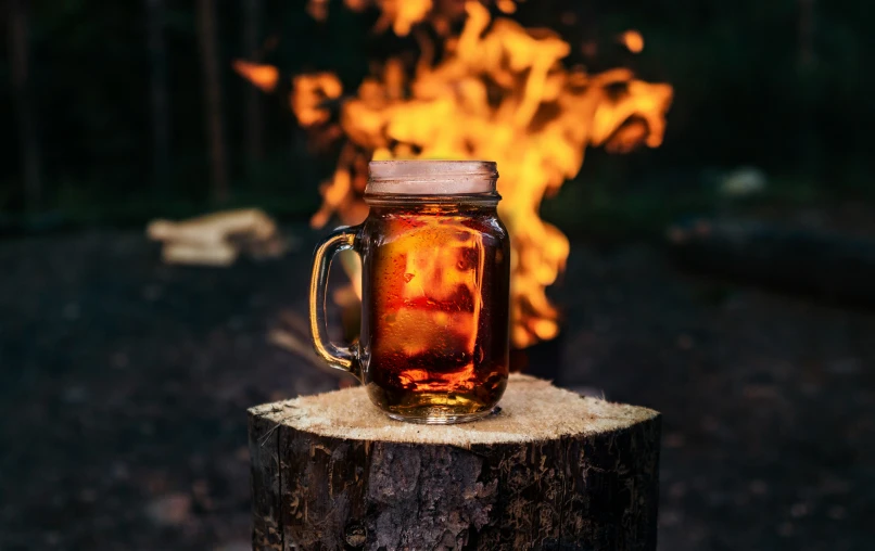 a fire is burning next to a jar