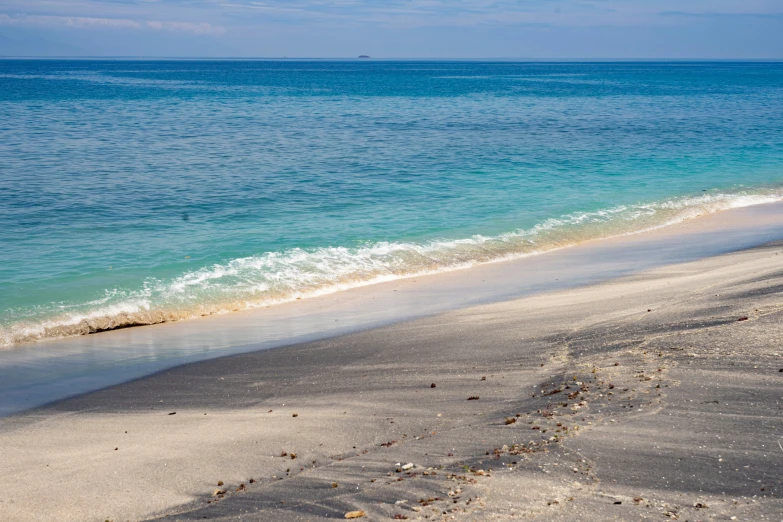 some water is on the sand at a beach