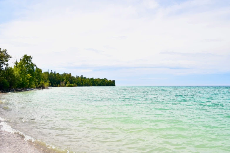 a beach is lined with people as it goes to the water