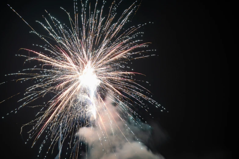 colorful fireworks in the night sky above some clouds