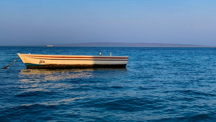 an empty boat in the middle of the ocean