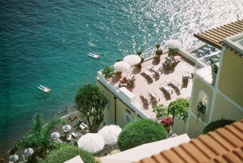 some umbrellas and beach chairs near the water