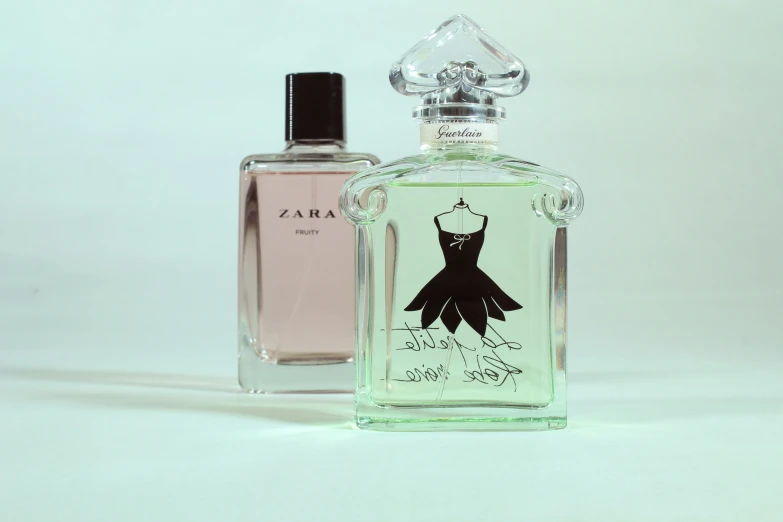 an unopened bottle of perfume in front of a glass case