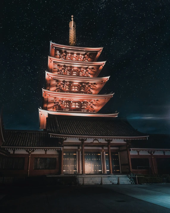 an asian building lit up by a lantern