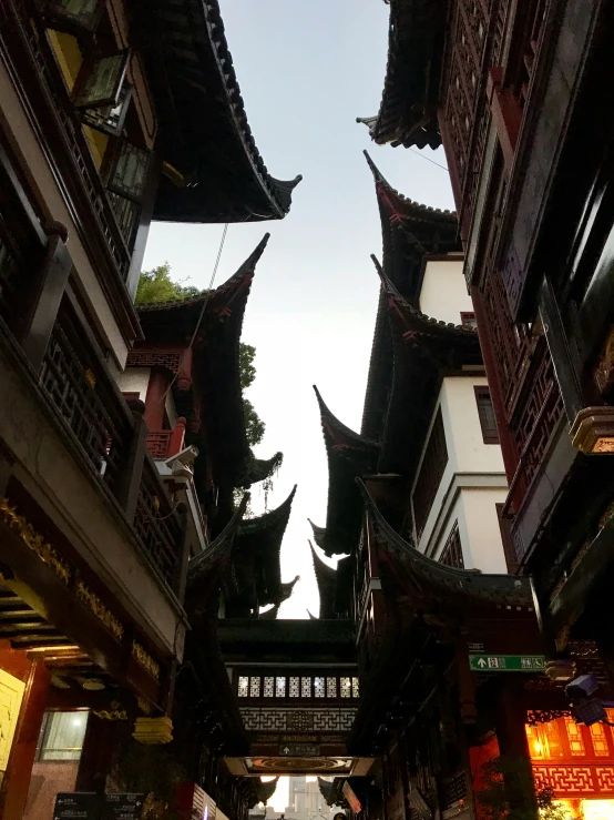 a very tall oriental building has many hanging lanterns