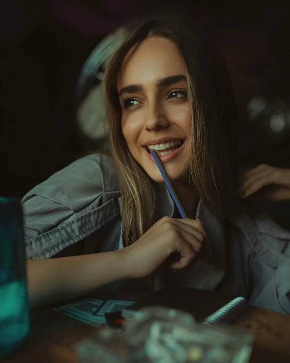 a woman smiles while holding the toothbrush