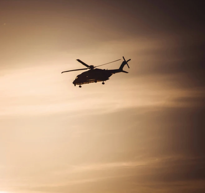 an image of the silhouette of a helicopter flying