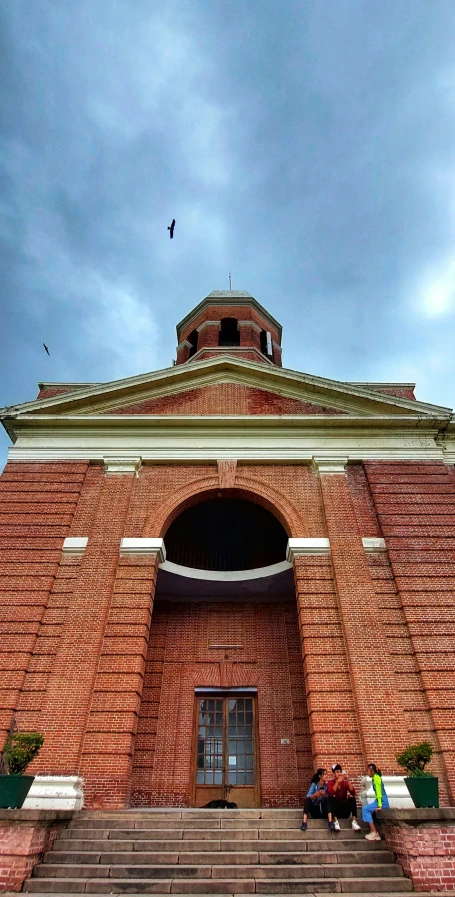 a brick church with steps and doors