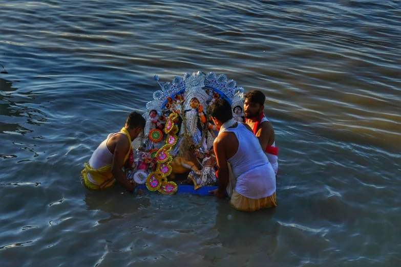 women in the water around a shrine