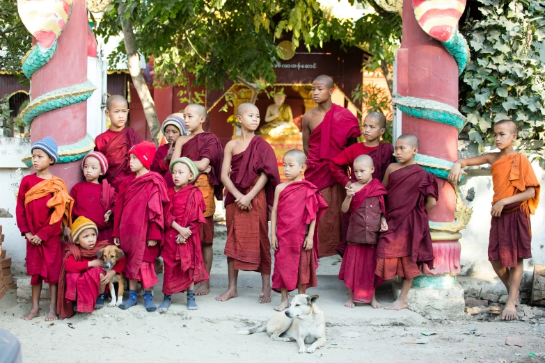 monks and their dog pose for a pograph at a monastery