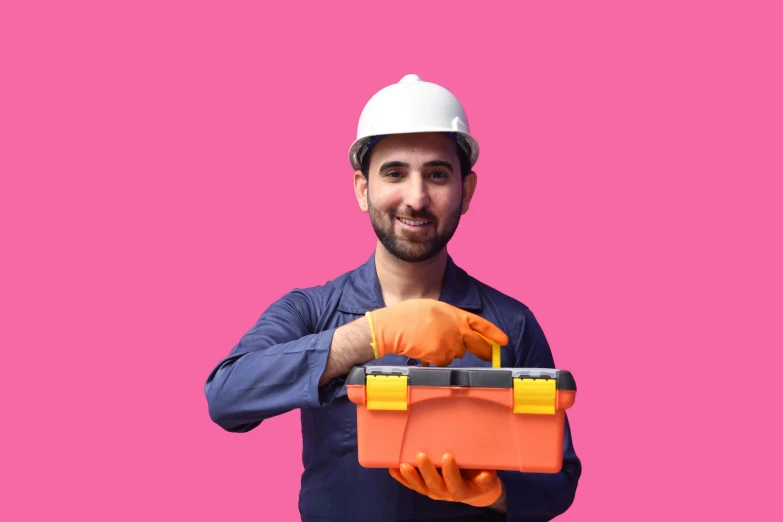 a smiling worker holding a box filled with orange gloves
