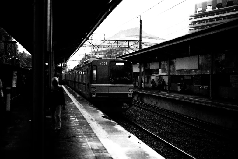 a train is parked on the train tracks at a station