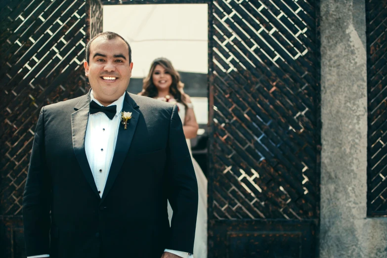 a smiling man in tuxedo and bow tie