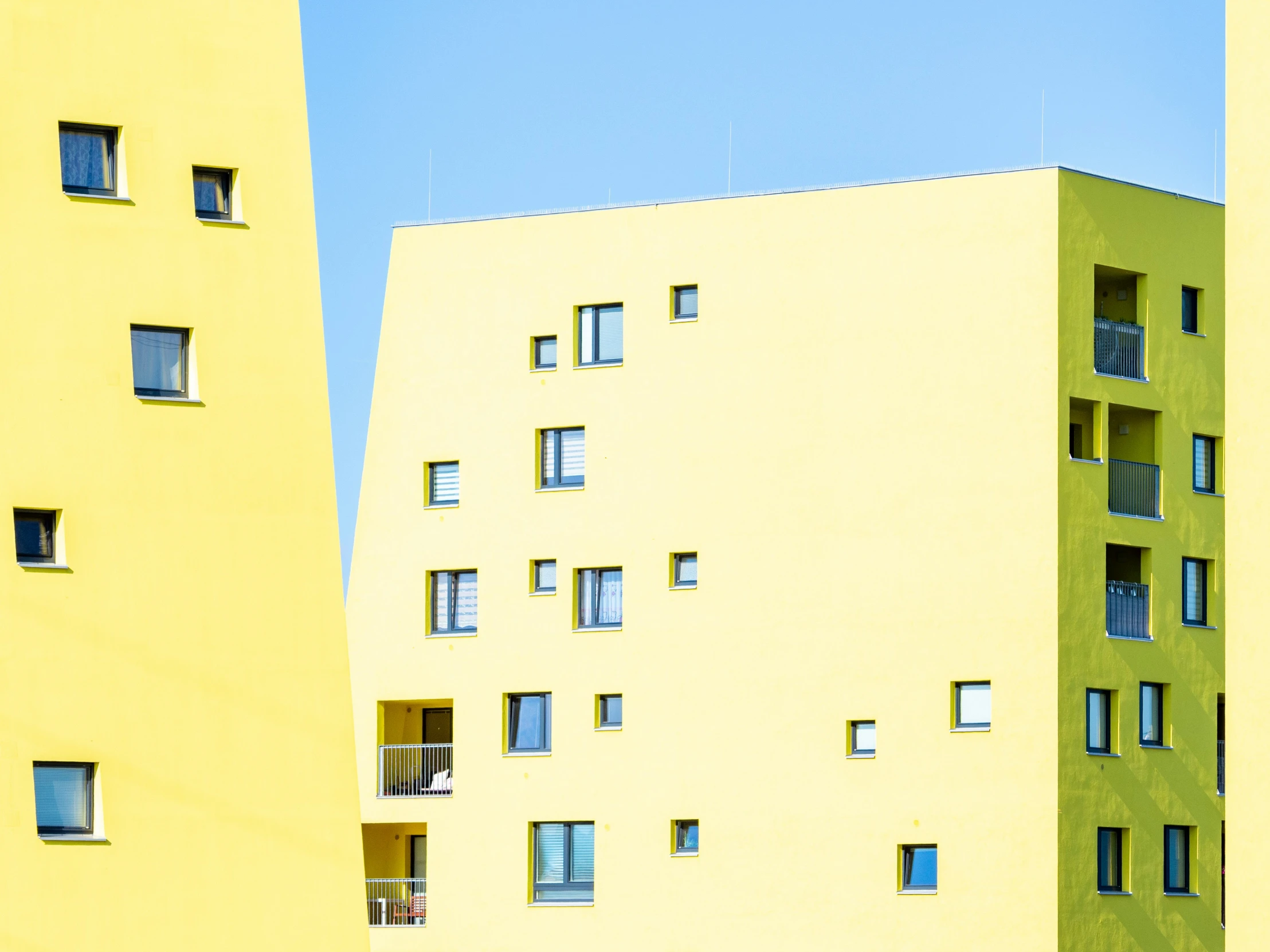 a building on the side with windows in yellow