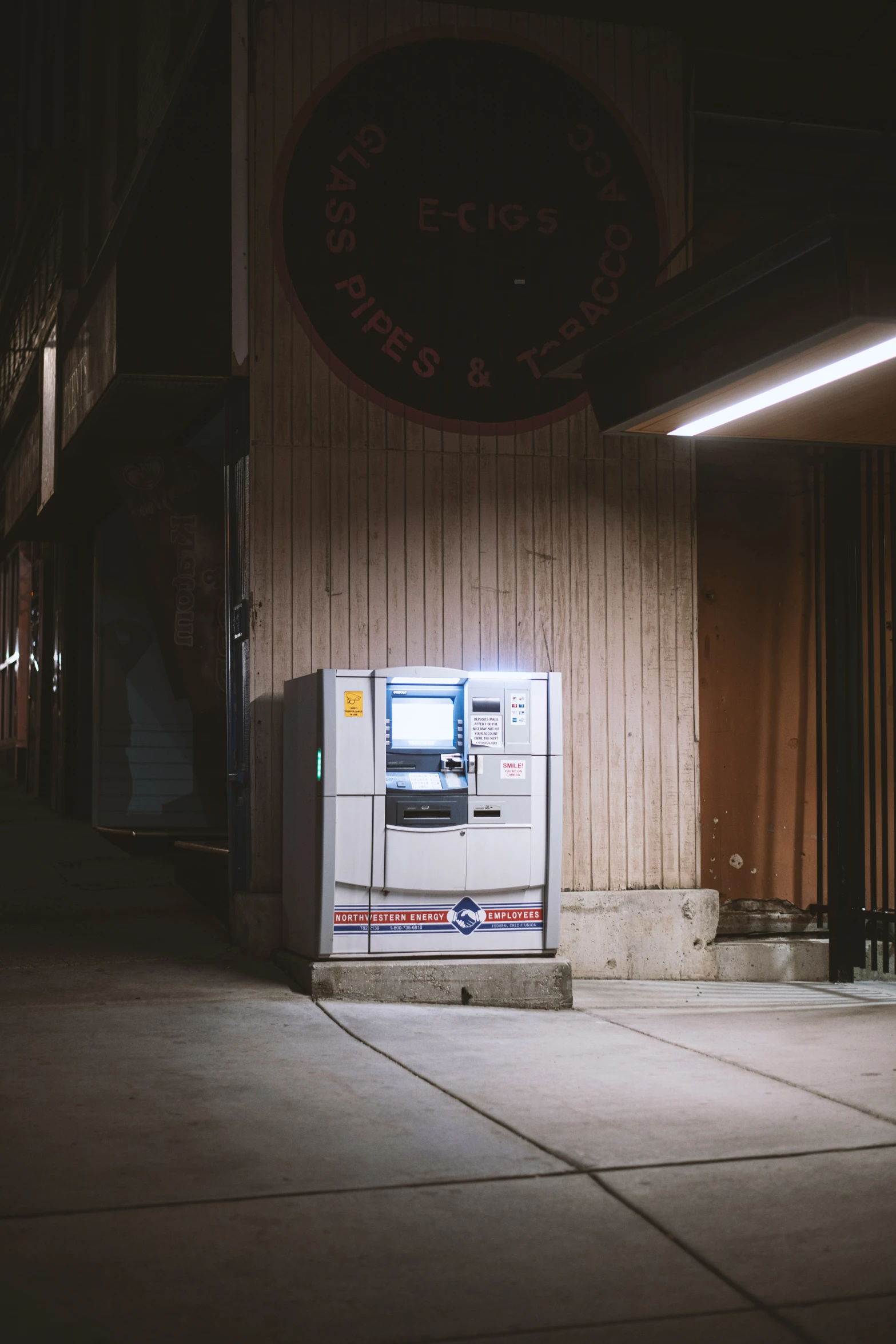 a telephone sitting on top of a street next to a building